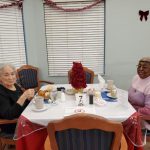 Two women residents eating dinner.