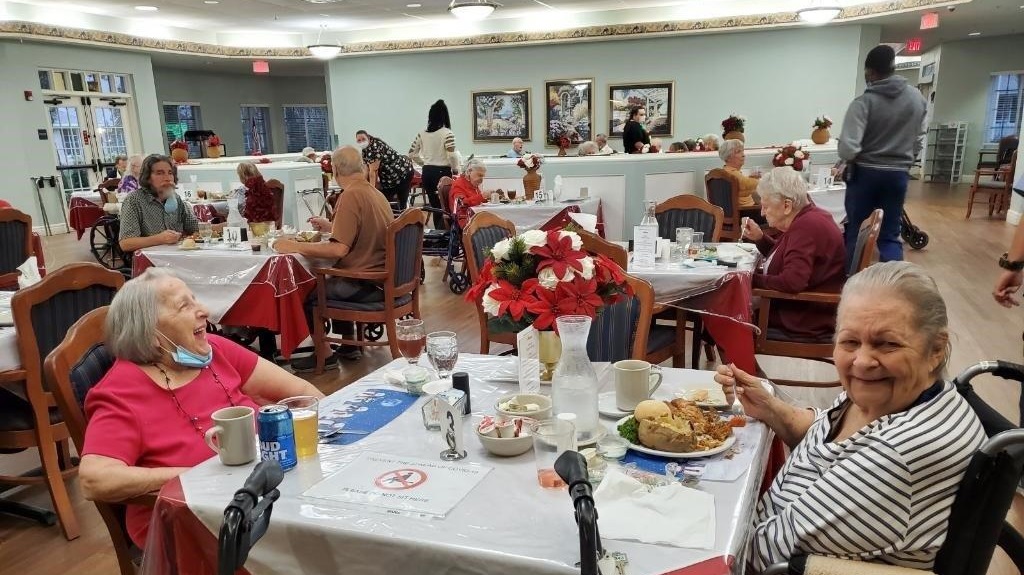 Resident and Staff Holiday Party with people eating.